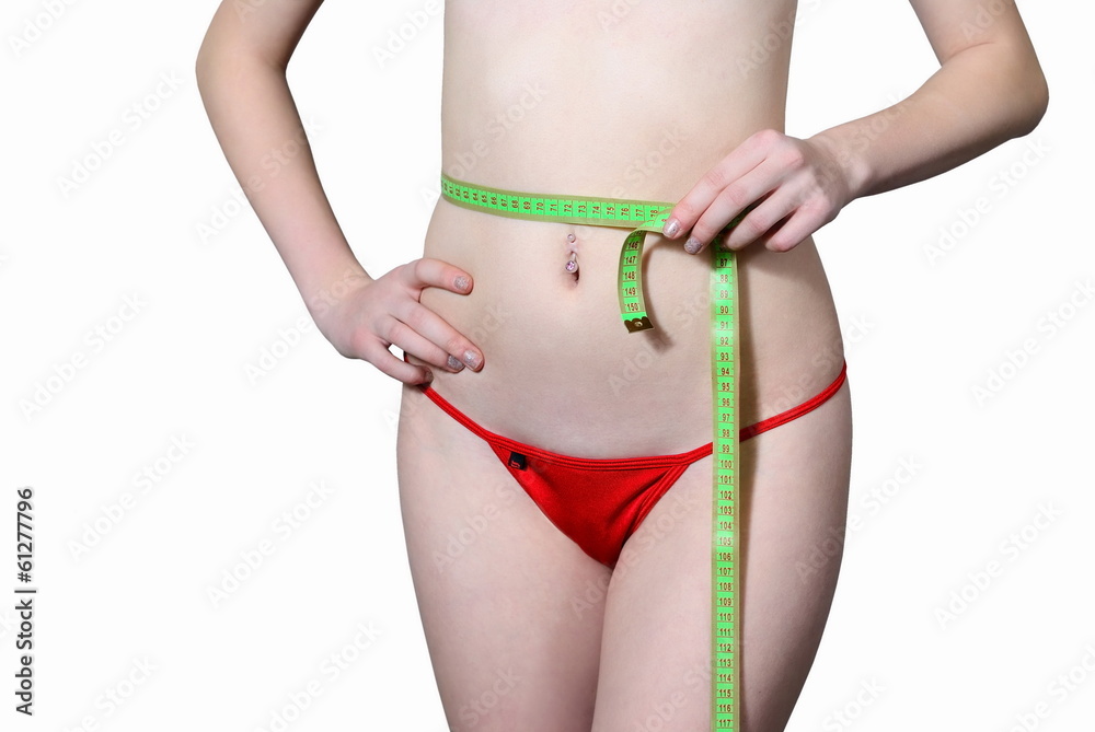 The girl measures the waist The girl measures the waist