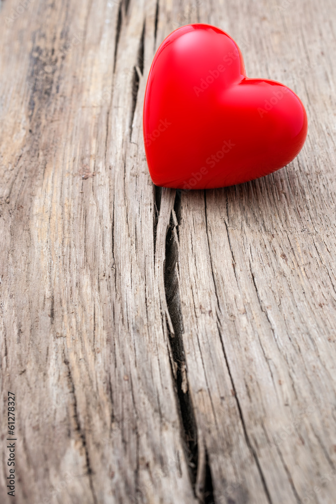 Red heart in crack of wooden plank Red heart in crack of wooden plank