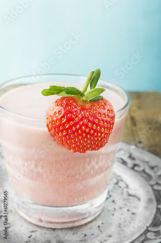Strawberry milk shake in silver plate mit berry on glass