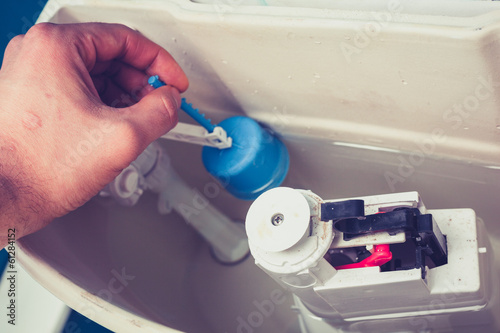 Photography Hand fixing toilet