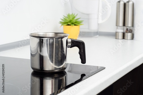 Mug in modern kitchen with induction stove