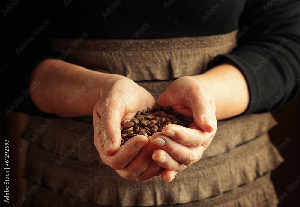 Senior woman holding coffee beans