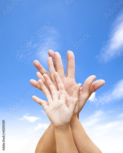 family united hands with blue sky and cloud