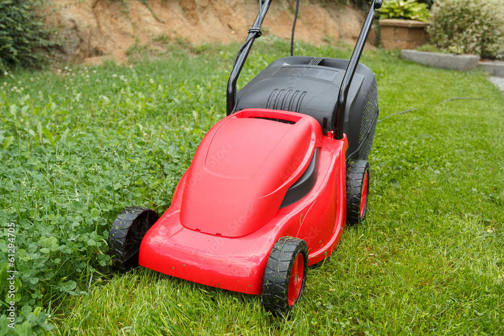 new lawnmower on green grass new lawnmower on green grass