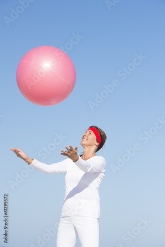 Fit healthy mature woman exercising with ball © roboriginal