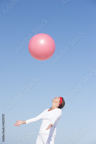 Joyful senior woman and flying exercise ball © roboriginal