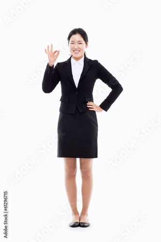 Successful happy Asian businesswoman showing thumb.