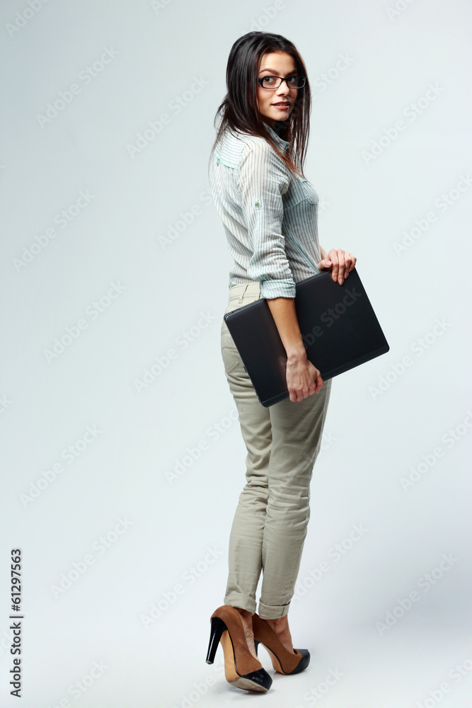 businesswoman holding laptop on gray background