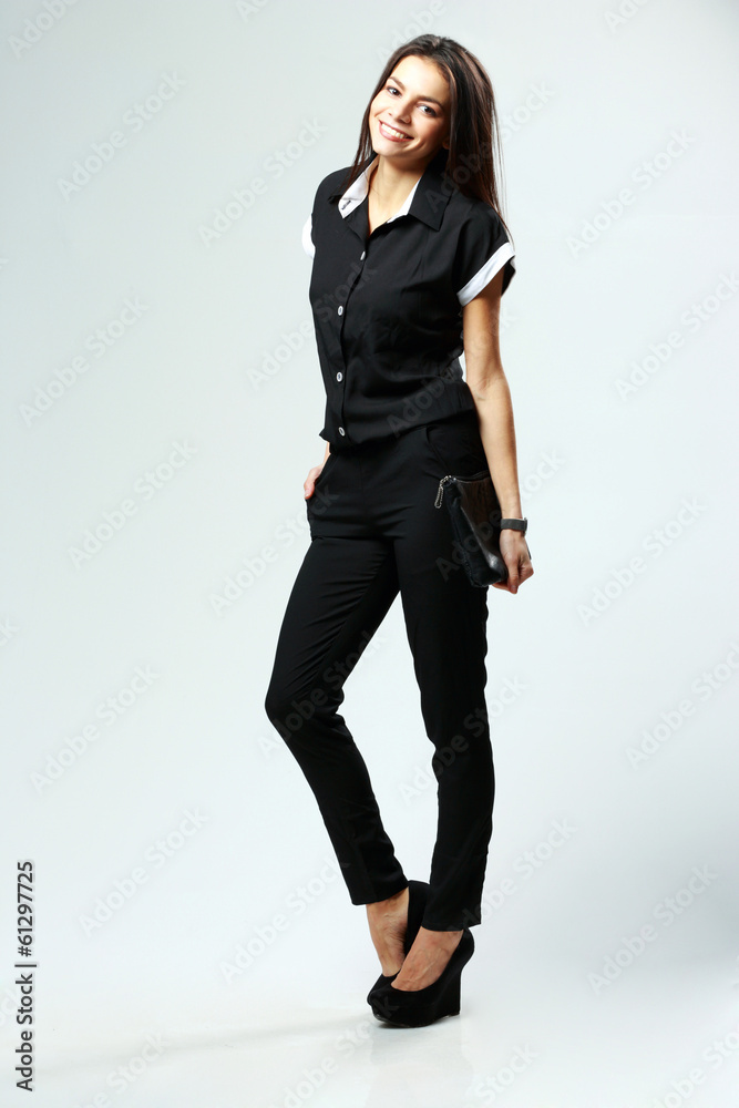 cheerful woman in style clothes standing on gray background cheerful woman in style clothes standing on gray background