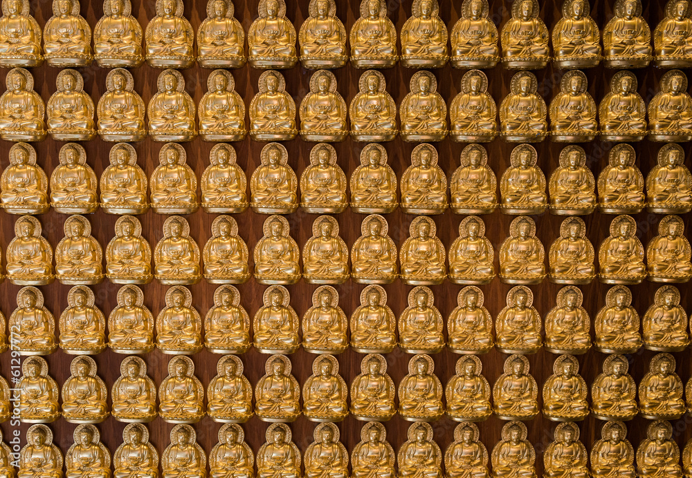 golden buddhas lined up along the wall of chinese temple