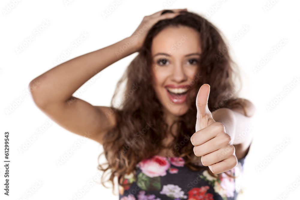 Smiling girl showing thumbs up on white background Smiling girl showing thumbs up on white background