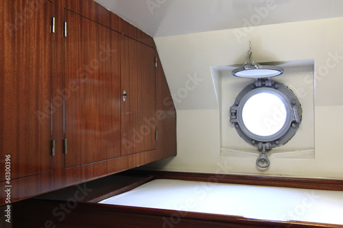 small cabin with porthole on a ship