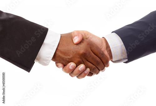 Handshake between african and a caucasian business man, isolated