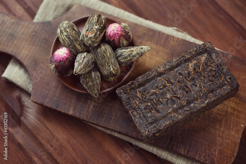 Above view of various compressed tea, vintage wooden background photo