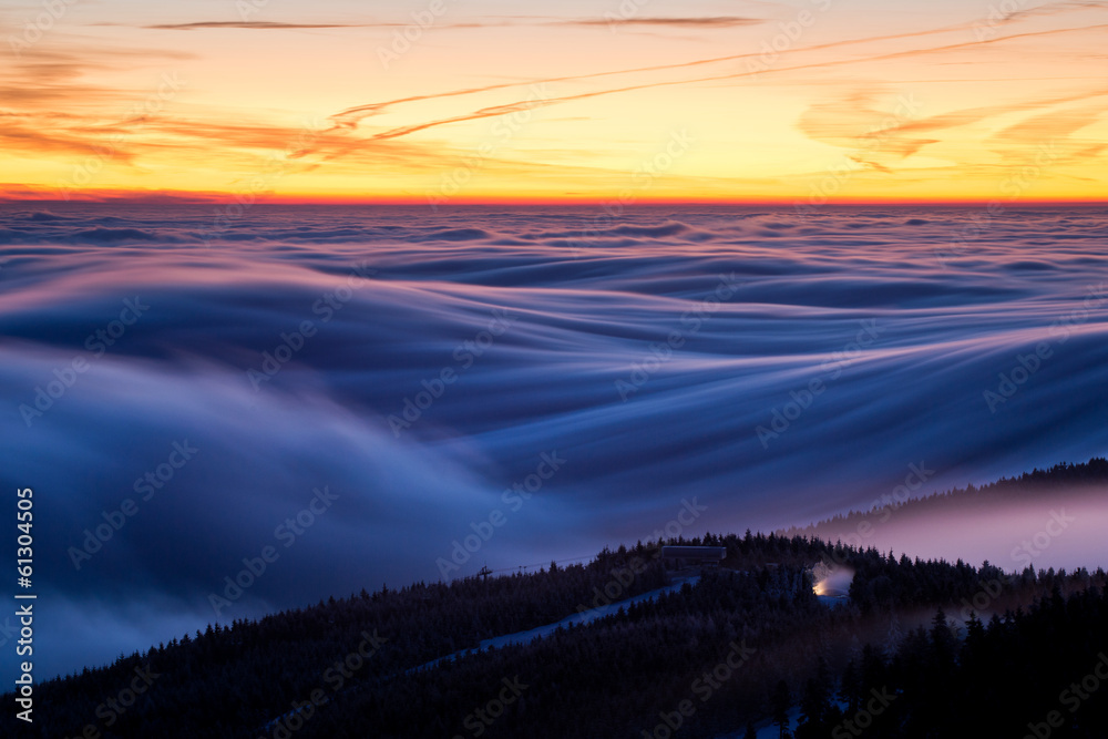 Inversion above the ski resort with lift and snow cannon