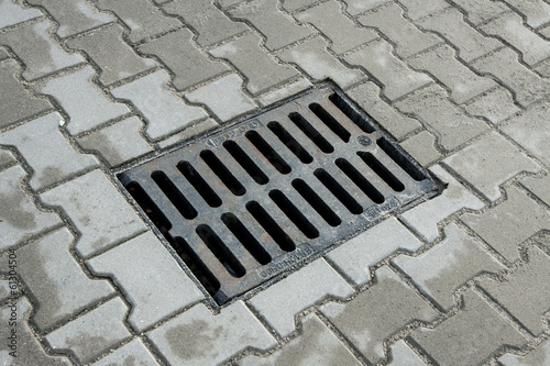 sewer manhole in the pavement photo