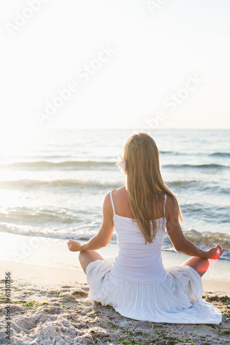 Young woman meditation on the beach