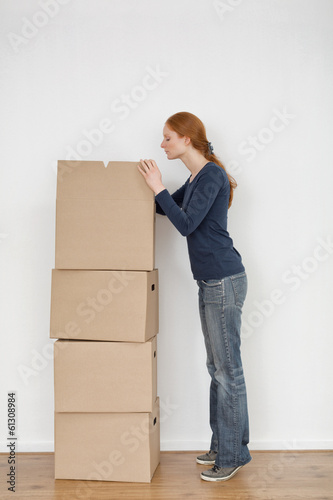 Young Woman Unpacking Boxes © ptnphotof