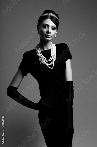 high fashion portrait of elegant woman in black dress and gloves