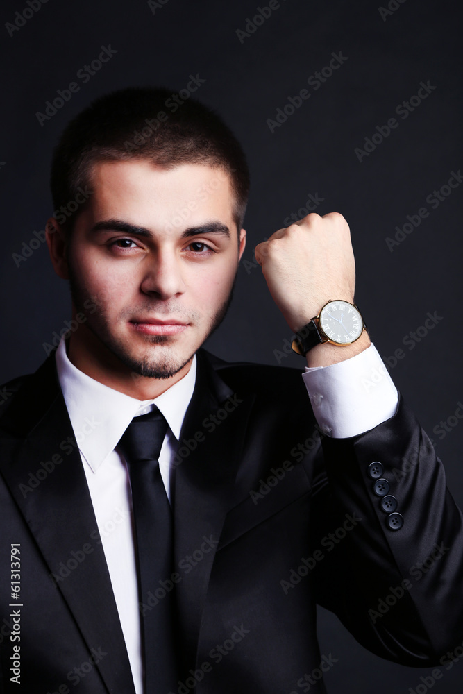 Handsome young man in suit on dark background Handsome young man in suit on dark background