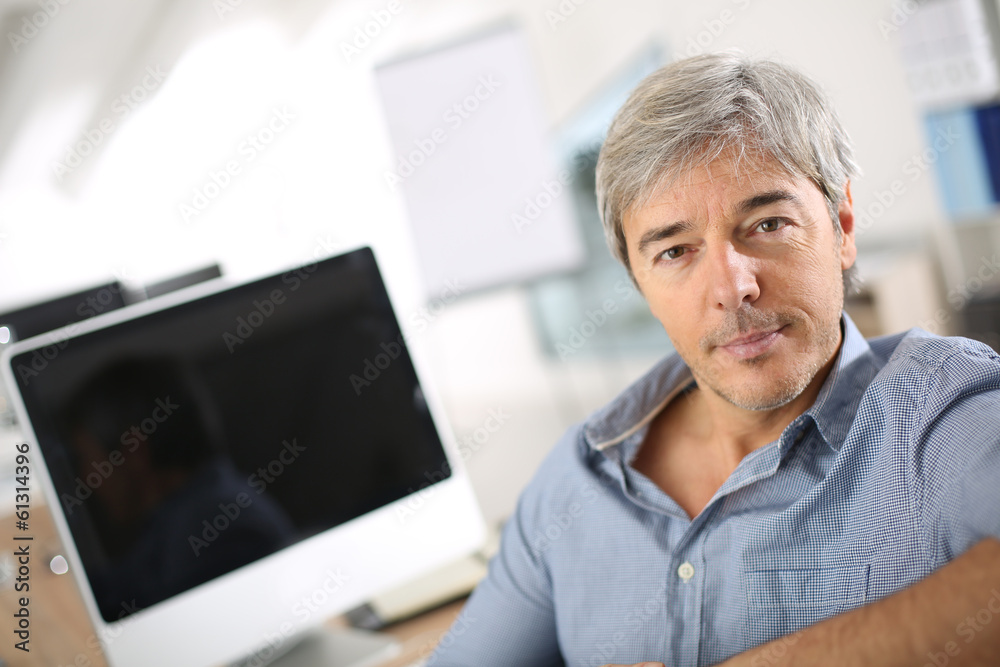 Businessman in office working on deskptop computer Businessman in office working on deskptop computer