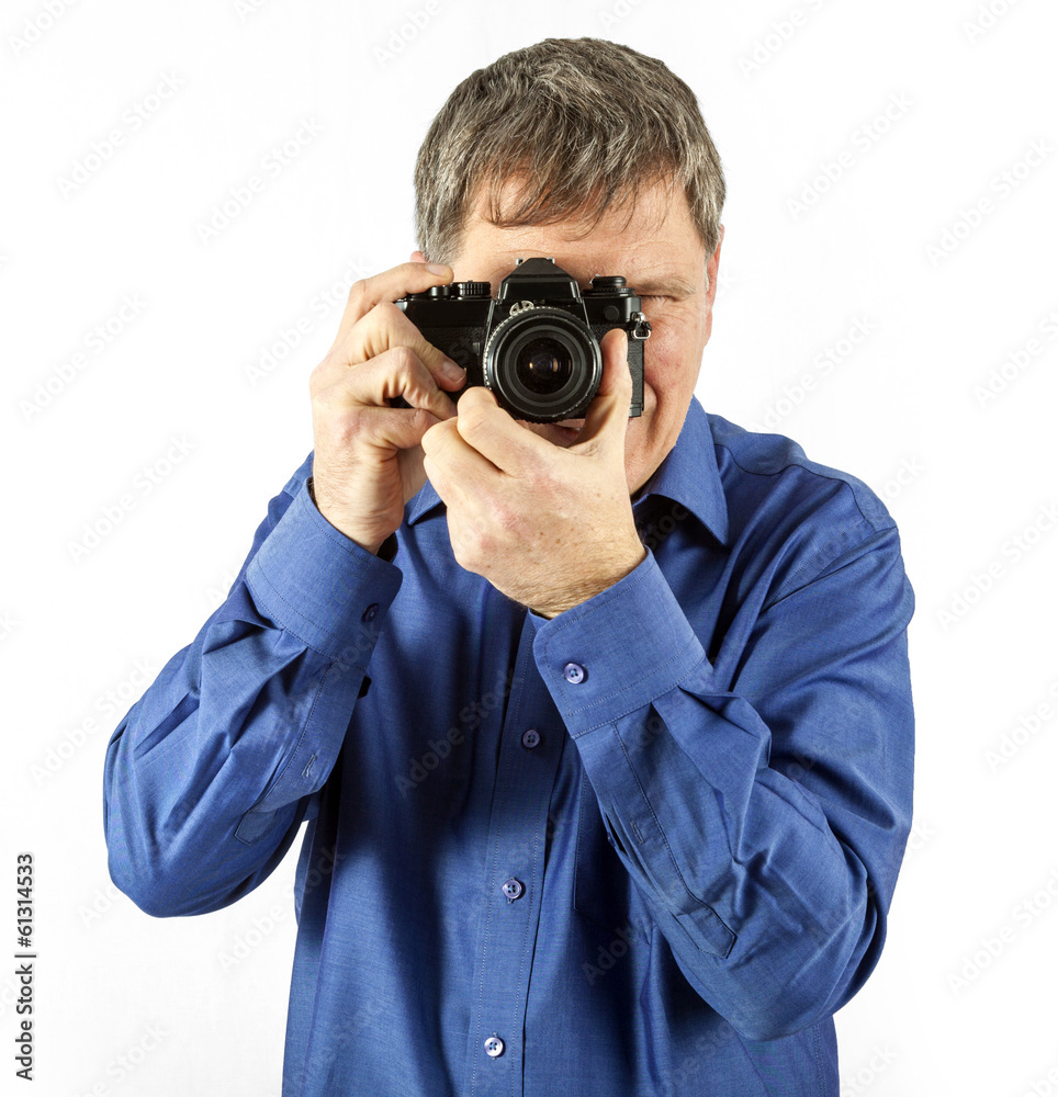 man takes a picture with an old analog camera man takes a picture with an old analog camera