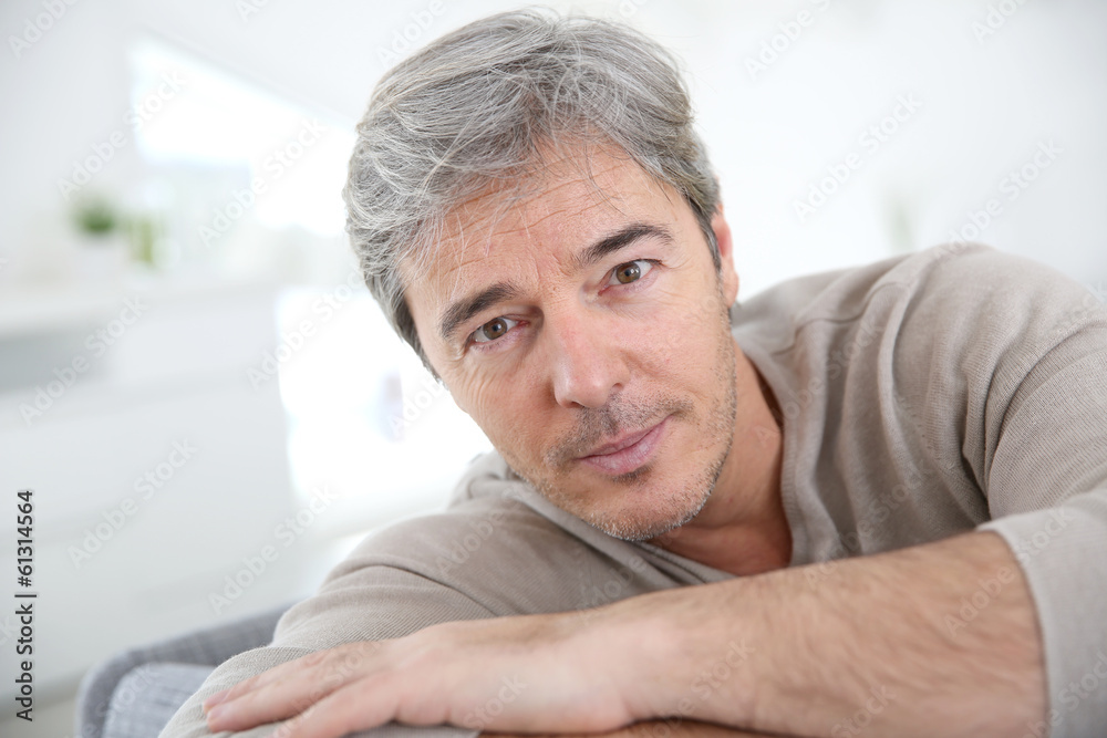 Portrait of mature man relaxing at home in sofa Portrait of mature man relaxing at home in sofa