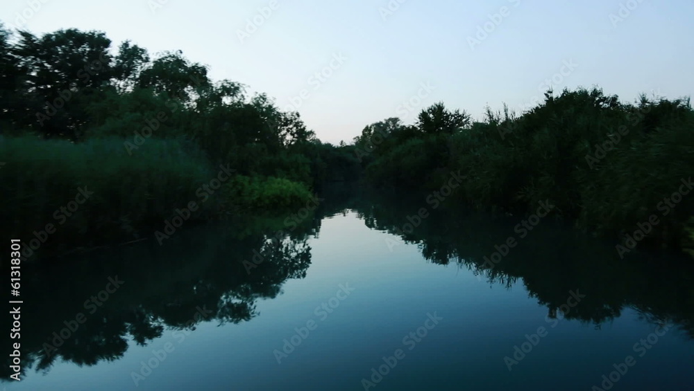 Driving a boat in a river Driving a boat in a river