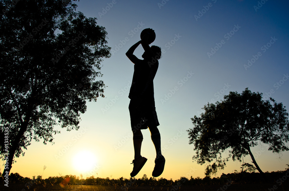 Player and basketball silhouette sunset background Player and basketball silhouette sunset background