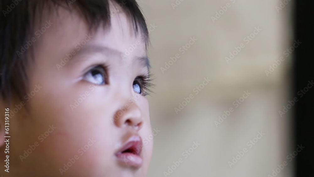 Closeup of baby face when looking television Closeup of baby face when looking television