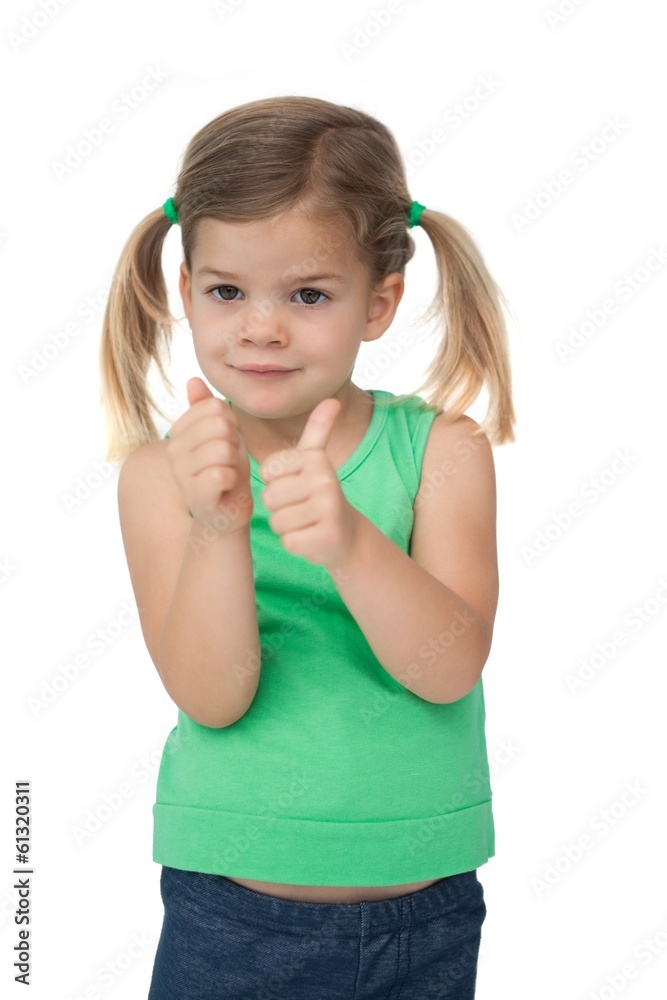 Cute little girl smiling at camera giving thumbs up Cute little girl smiling at camera giving thumbs up