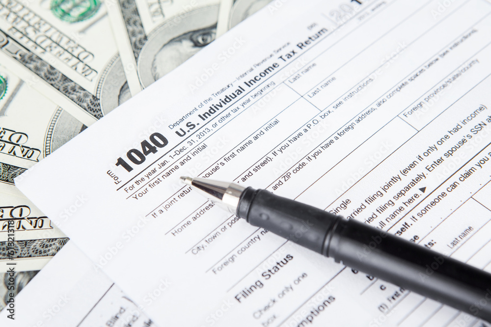 Tax forms with dollar bills