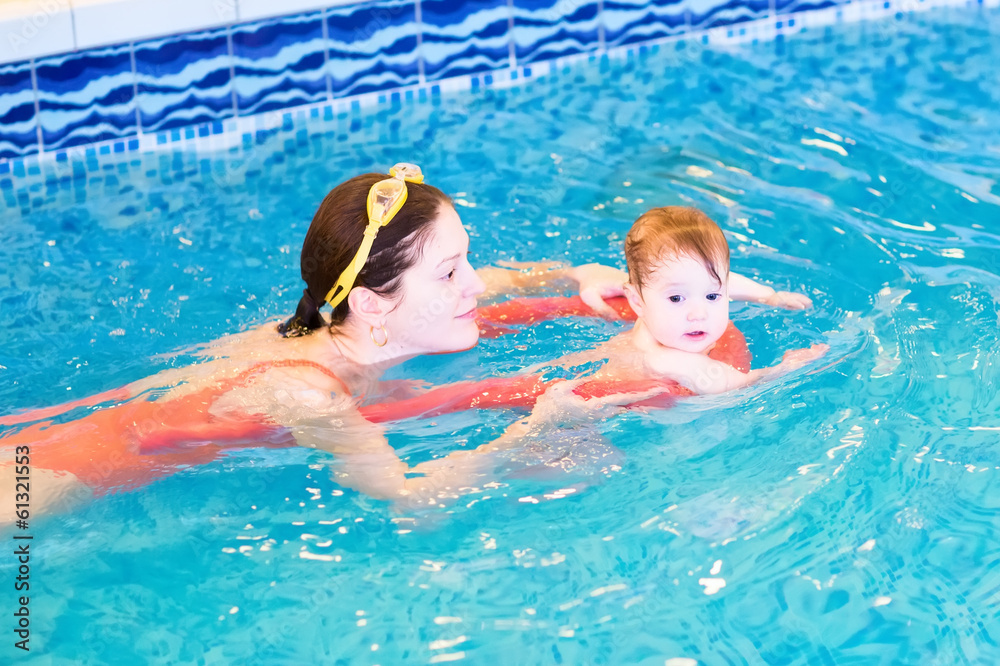 Young mother with a little baby in the swimming pool