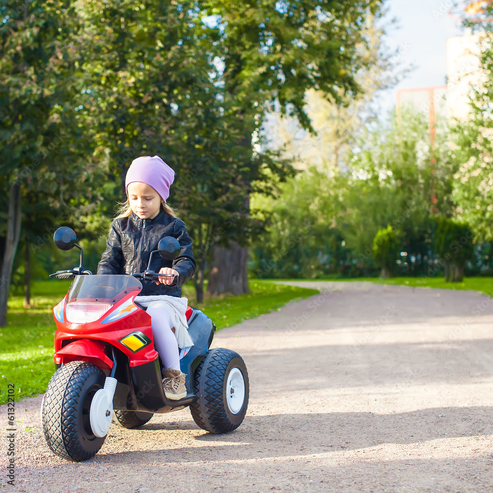 Adorable little girl riding a children's bike Adorable little girl riding a children's bike