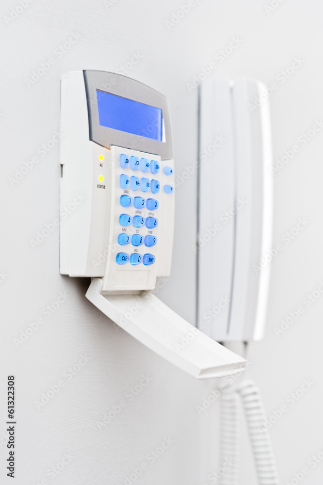Security system panel with blue screen during day Security system panel with blue screen during day