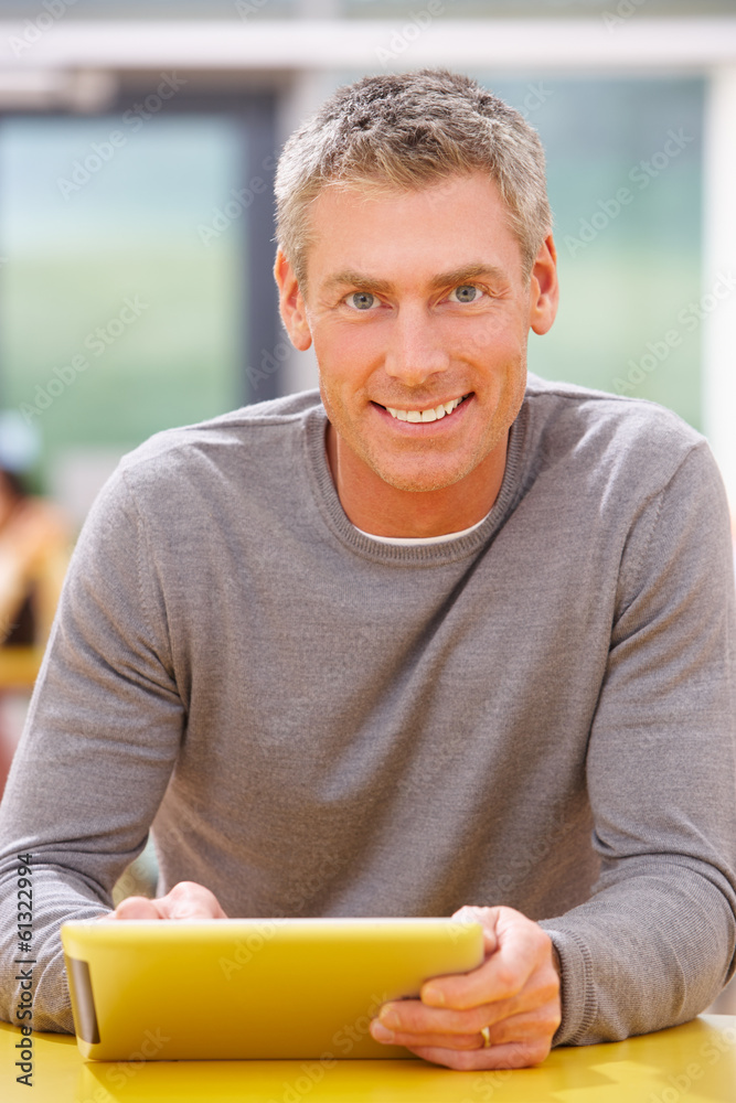 Mature Student Studying In Classroom With Digital Tablet Mature Student Studying In Classroom With Digital Tablet