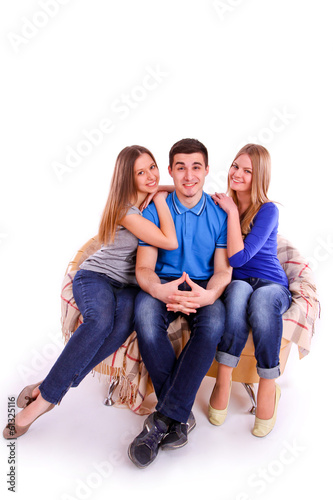 Guy with two girls sitting on the couch