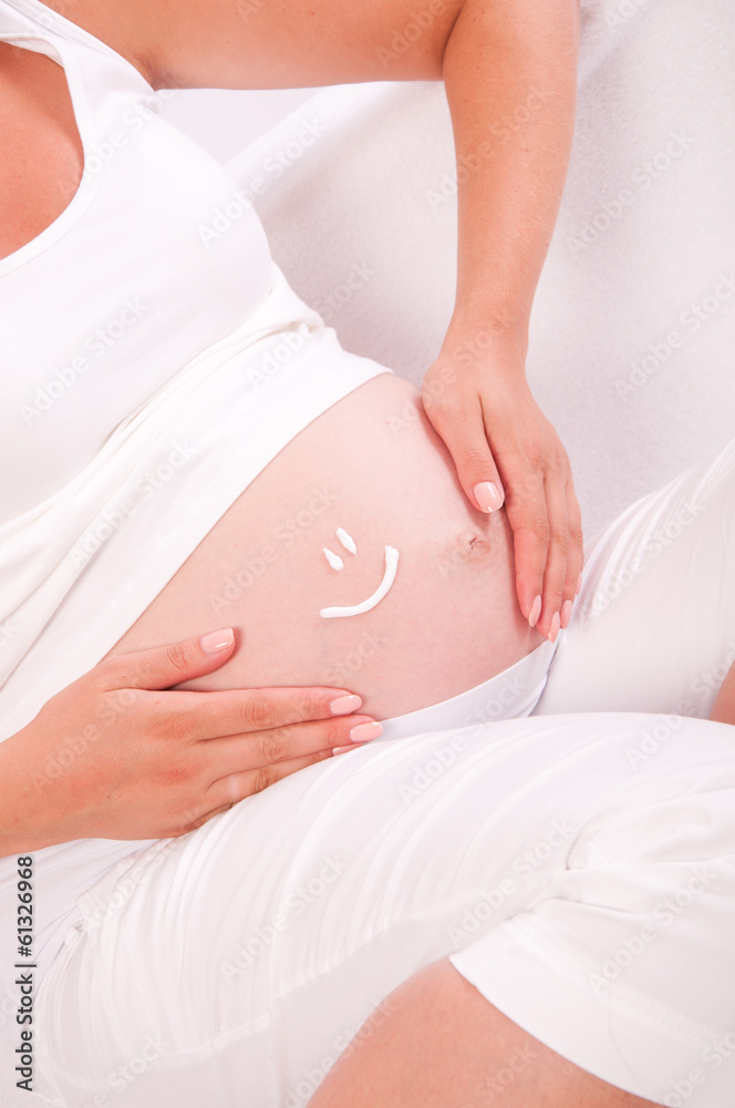 Belly of pregnant woman with smile symbol on it Belly of pregnant woman with smile symbol on it