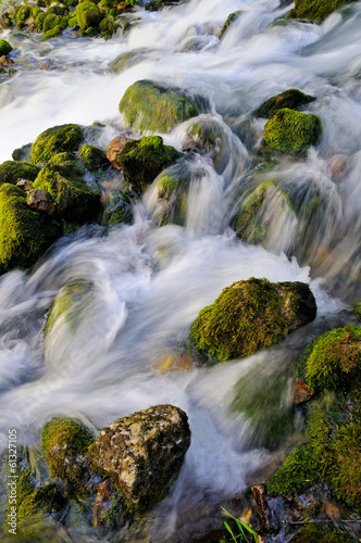 Water flowing over mossy rocks