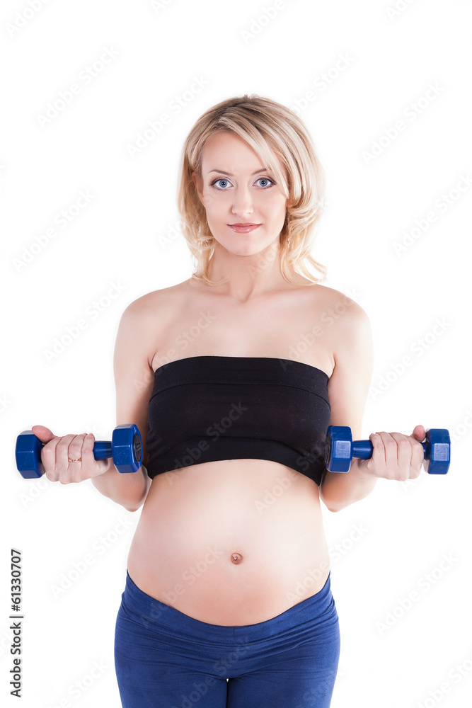 A pregnant woman exercising with a light weights - isolated A pregnant woman exercising with a light weights - isolated