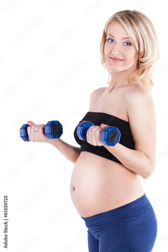 A pregnant woman exercising with a light weights - isolated A pregnant woman exercising with a light weights - isolated