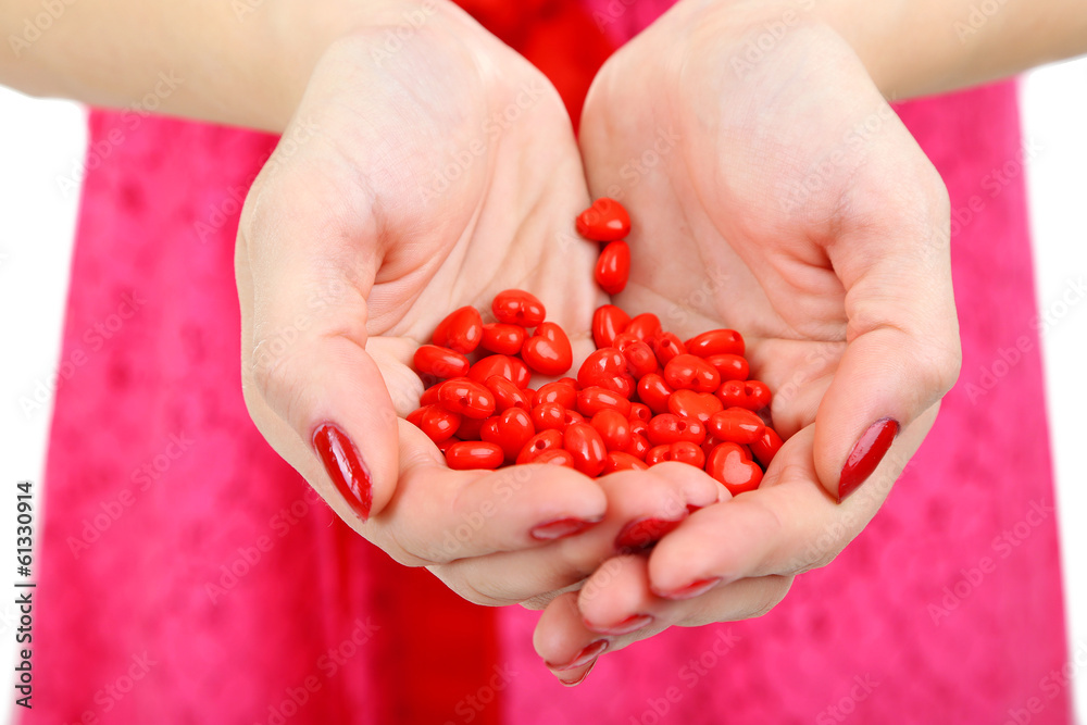 Young woman with holding little hearts in hands close up Young woman with holding little hearts in hands close up