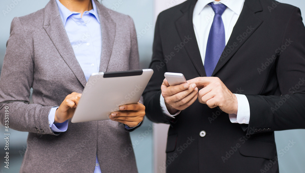 two businesspeople with smartphone and tablet pc two businesspeople with smartphone and tablet pc