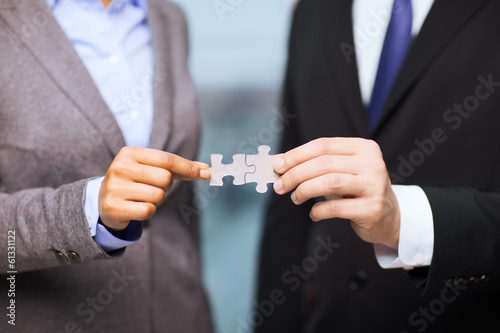 businessman and businesswoman with puzzle pieces