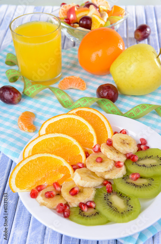 Sweet fresh fruits on plate on table close-up