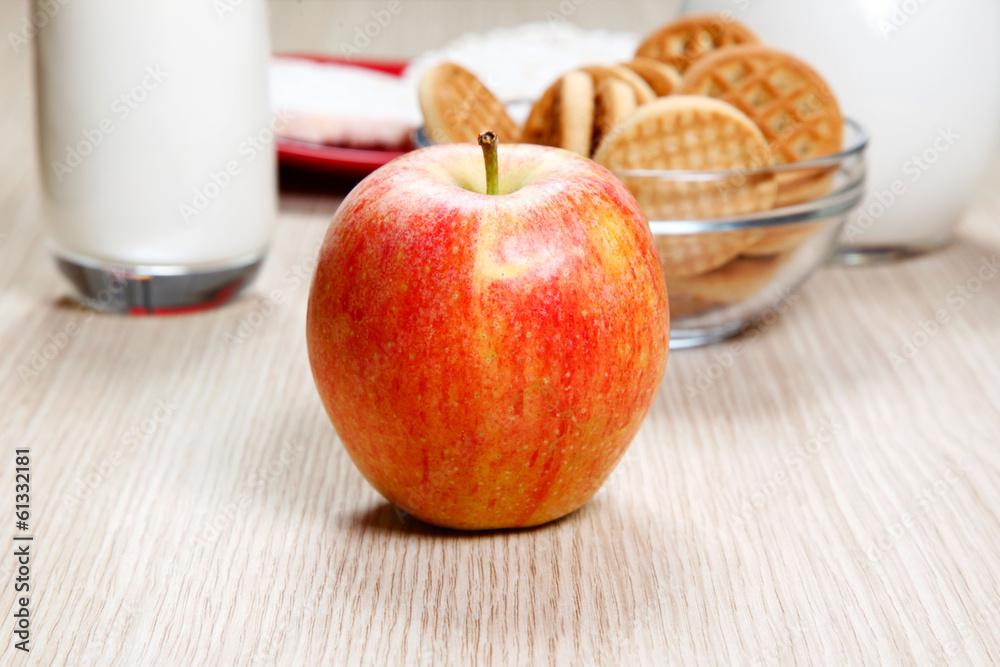 An apple and cookies on table An apple and cookies on table