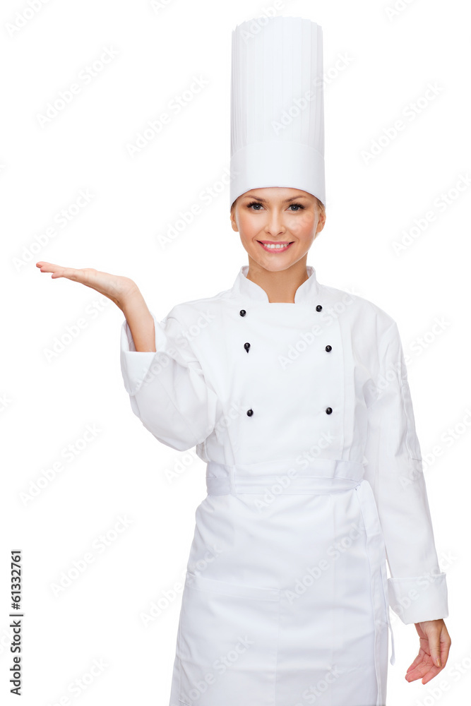 smiling female chef holding something on hand smiling female chef holding something on hand