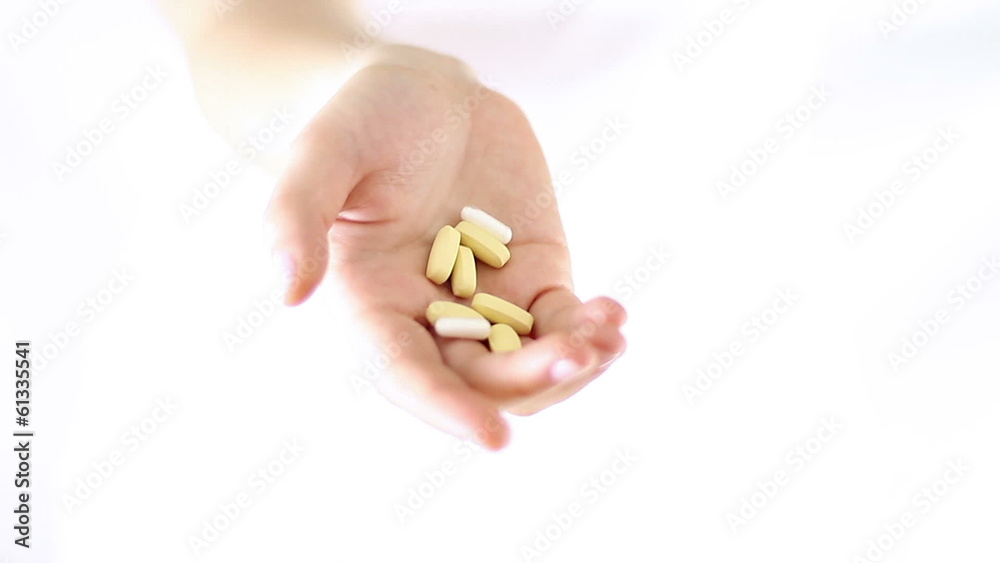 Hands Offering, showing pills - Studio shot Hands Offering, showing pills - Studio shot