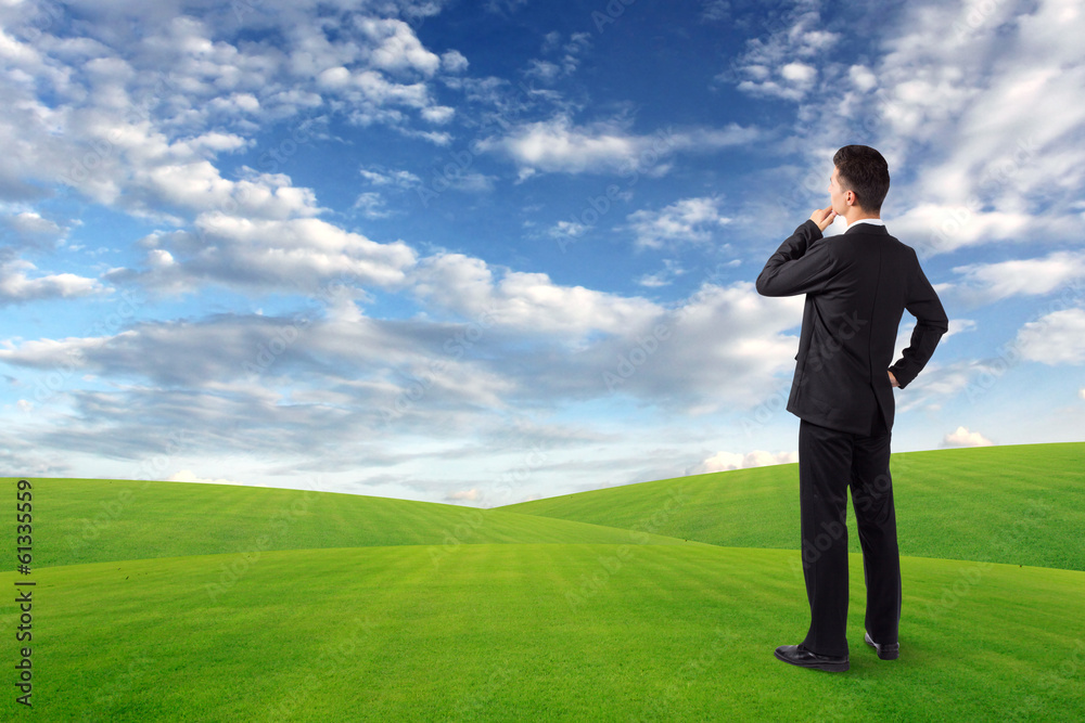 Thinking man standing on the lawn and clouds sky Thinking man standing on the lawn and clouds sky