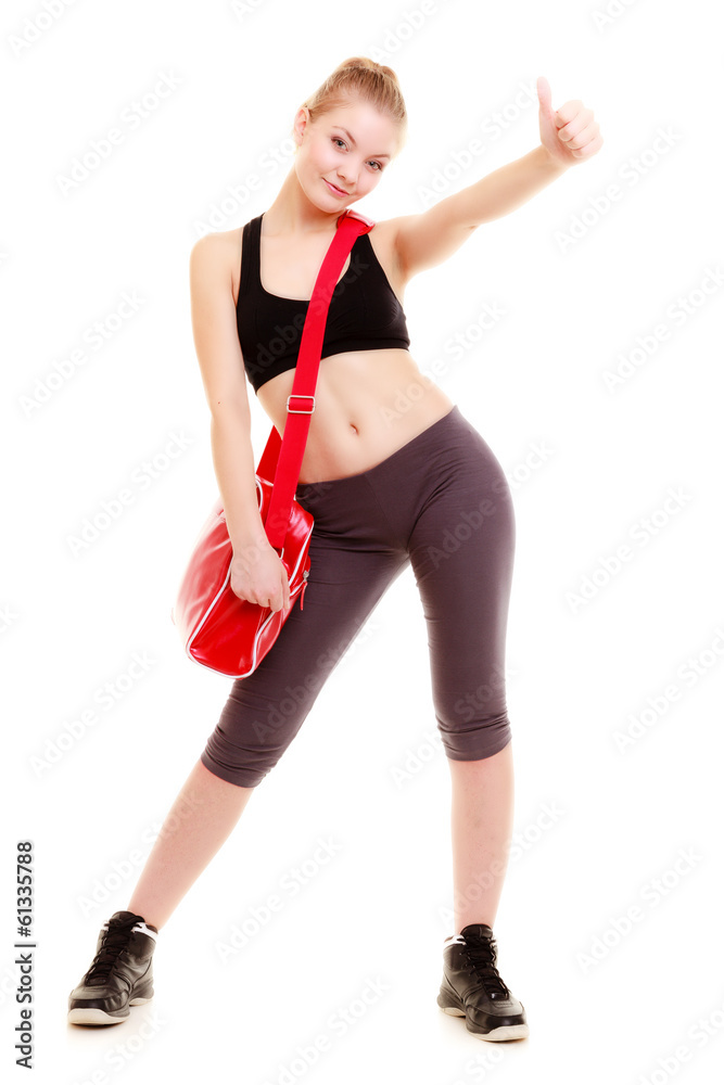 Happy sporty girl holds red gym bag ready for fitness exercise